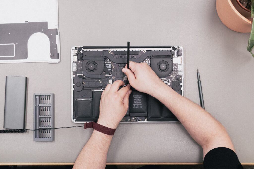 macbook repair pricing - specialist repairing a macbook