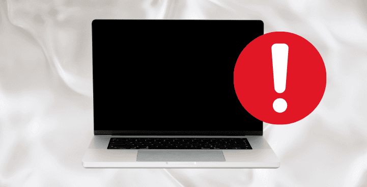 A MacBook with a black screen, indicating that it is not turning on. A red warning icon with an exclamation mark is displayed, symbolizing an issue with the device.